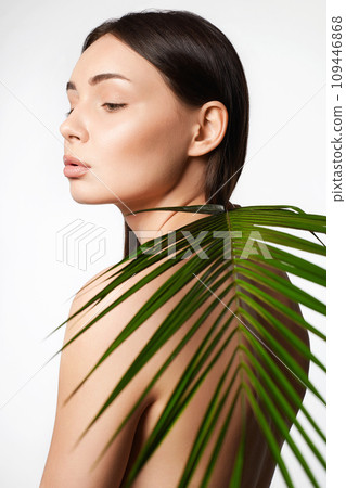 beautiful girl with palm leaves. Beautiful young naked woman beautiful girl with palm leaves. Beautiful young naked woman 109446868