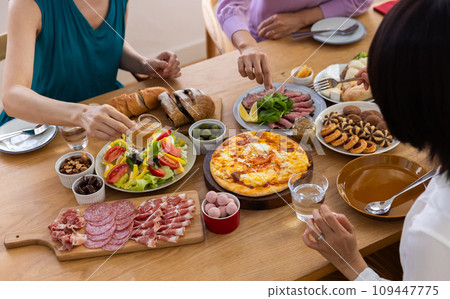 A woman eating food on a table 109447775