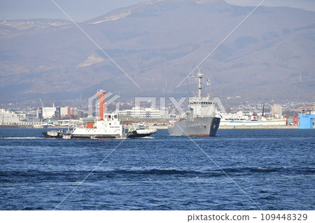 Photographing the scenery of a Self-Defense Force ship being towed to Hakodate dock at Hakodate Port in Hakodate City, Hokkaido in winter 109448329