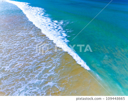 Aerial view of Waves crashing on sandy shore,Sea surface ocean waves background,Top view beach background Aerial view of Waves crashing on sandy shore,Sea surface ocean waves background,Top view beach background 109448665