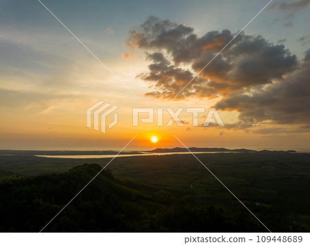 Aerial view colorful sky over mountains tropical rainforest,Bird eye view image over the fog, Amazing nature background with clouds and mountain peaks in Thailand Aerial view colorful sky over mountains tropical rainforest,Bird eye view image over the fog, Amazing nature background with clouds and mountain peaks in Thailand 109448689