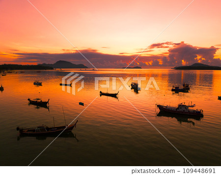 Amazing sunset or sunrise sky over sea landscape,Beautiful colorful light of nature with boats in the sea,Drone camera shot,Top down nature view seascape Amazing sunset or sunrise sky over sea landscape,Beautiful colorful light of nature with boats in the sea,Drone camera shot,Top down nature view seascape 109448691