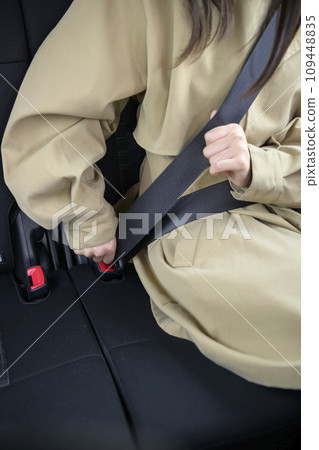 A person wearing a seatbelt in the back seat 109448835