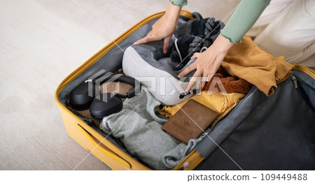 Traveler woman packing prepare stuff and outfit clothes in suitcases travel bag luggage for holiday at home, weekend, tourist, journey Traveler woman packing prepare stuff and outfit clothes in suitcases travel bag luggage for holiday at home, weekend, tourist, journey 109449488