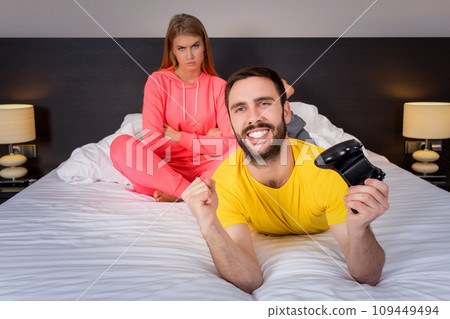 Young couple having playing videogames in bed 109449494