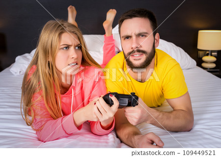 Young couple having playing videogames in bed 109449521