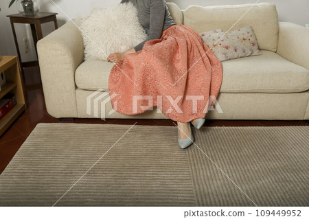 Closeup of an attractive young model woman lying on sofa indoor Closeup of an attractive young model woman lying on sofa indoor 109449952