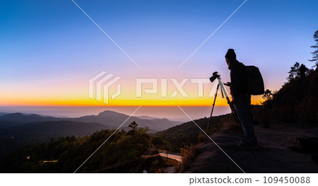 Silhouette Photographer take a landscape photo at twilight sunrise 109450088