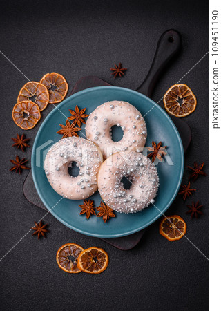 Delicious fresh donut of white or beige color with silver beads and cream 109451190