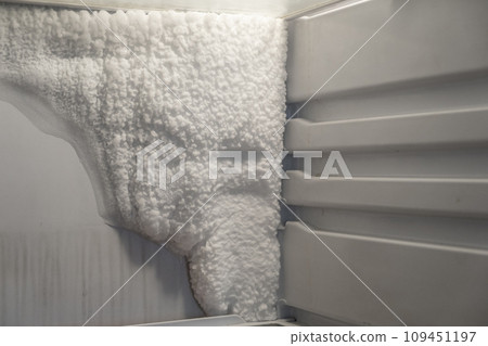 Frozen refrigerator that needs to be defrosted. Block of ice in the empty fridge. empty shelves in the refrigerator. Refrigerator maintenance. Frozen refrigerator that needs to be defrosted. Block of ice in the empty fridge. empty shelves in the refrigerator. Refrigerator maintenance. 109451197