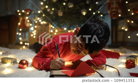 Kid writing Christmas letter for santa Claus Kid writing Christmas letter for santa Claus 109451351