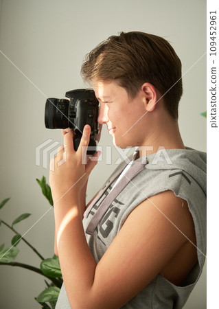 a boy with camera in his hands a boy with camera in his hands 109452961