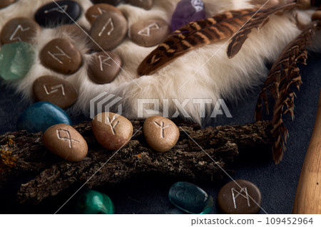 handmade stone runes on white fur 109452964