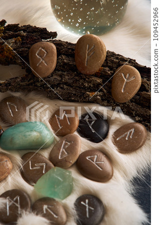 handmade stone runes on white fur handmade stone runes on white fur 109452966