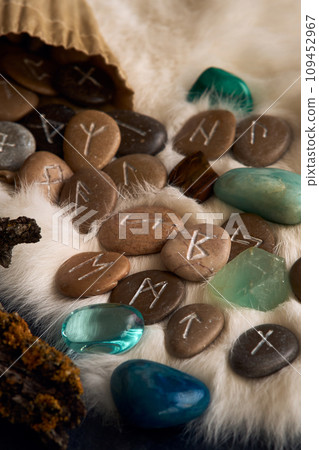 handmade stone runes on white fur handmade stone runes on white fur 109452967