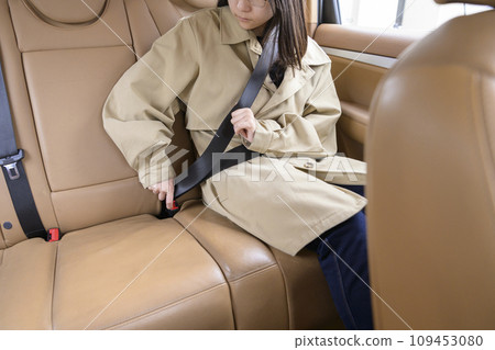 A person wearing a seatbelt in the back seat 109453080
