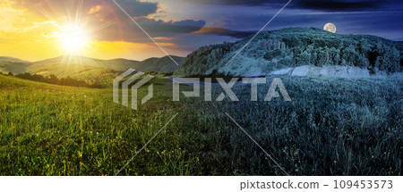 mountainous landscape with asphalt road winding through the valley with sun and moon on the sky. day and night time change concept. panorama of countryside scenery in morning light at summer solstice 109453573