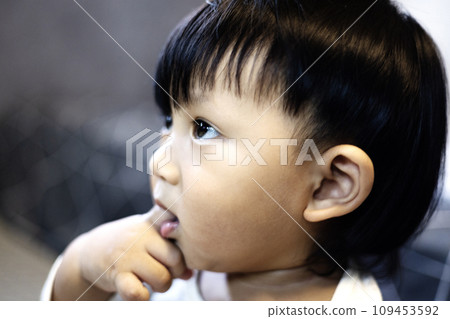 Close up Asian baby boy sucking finger in mouth. Adorable little Asian baby boy sucking finger in mouth. 109453592