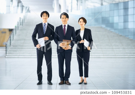Smiling business people lined up in the office Smiling business people lined up in the office 109453831