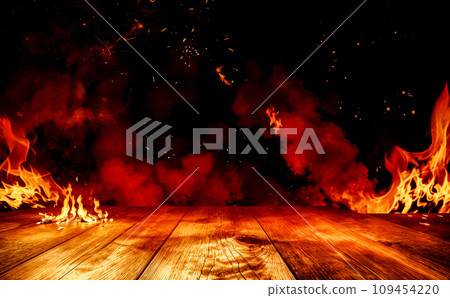 wooden table with Fire burning, fire particles, sparks, and smoke. Wood texture board in front with flying flakes from hot flame, glowing and bright burning blaze 109454220