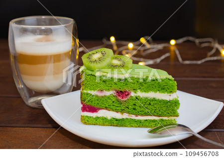Pistachio cake with kiwi, cream and raspberry filling and Cappuccino coffee Pistachio cake with kiwi, cream and raspberry filling and Cappuccino coffee 109456708
