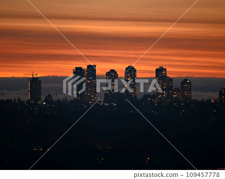 City lights after sunset on darker sky and cumulus clouds background 109457778