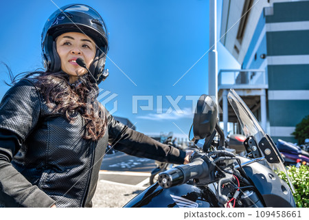 A female rider touring Yokohama on a cruiser bike A female rider touring Yokohama on a cruiser bike 109458661