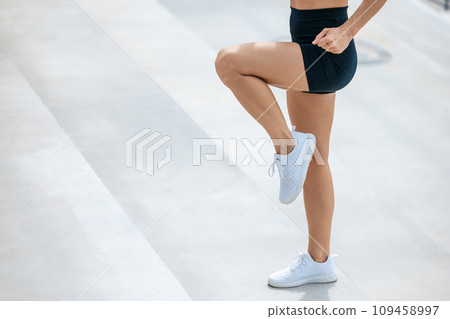 Close up of an exercising female in black sports shorts 109458997