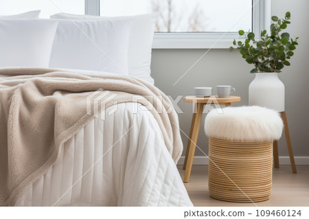 Neutral Scandi-style interior with hygge furniture in the bedroom. Linen bed or bedding. Close up interior details photo. Flowers in a vase for interior decoration. Neutral Scandi-style interior with hygge furniture in the bedroom. Linen bed or bedding. Close up interior details photo. Flowers in a vase for interior decoration. 109460124