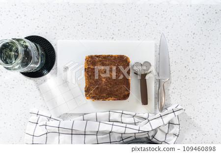 Flat lay. Scoring chocolate peanut butter fudge for cutting into small pieces. 109460898