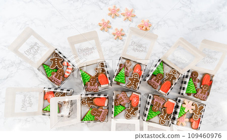 Flat lay. Packaging a homemade variety of fudge and gingerbread cookies for Christmas food gifts into paper boxes. Flat lay. Packaging a homemade variety of fudge and gingerbread cookies for Christmas food gifts into paper boxes. 109460976