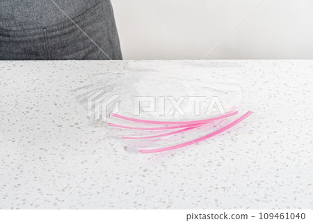 Empty plastic bags to package homemade frozen shrimp scampi meal prep. 109461040