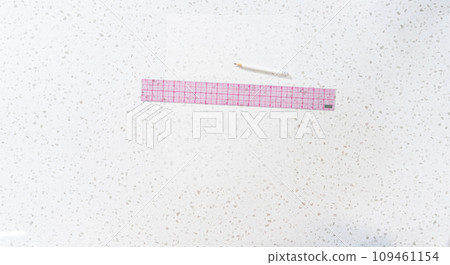 Flat lay. Preparing cutting template from parchment paper to cut homemade fudge. Flat lay. Preparing cutting template from parchment paper to cut homemade fudge. 109461154