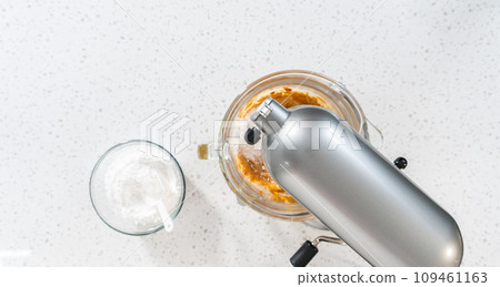 Flat lay. Whipping ingredients in a stand electric mixer to make dulce de leche buttercream frosting. Flat lay. Whipping ingredients in a stand electric mixer to make dulce de leche buttercream frosting. 109461163