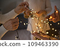 A family is unraveling a New Year's Christmas garland. 109463390