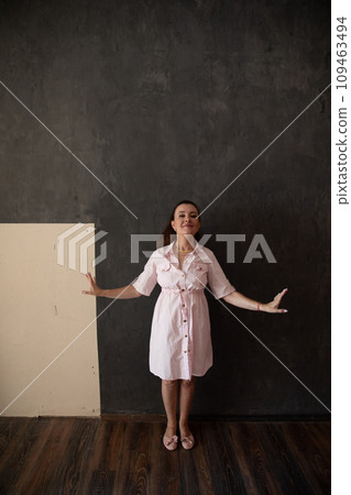 brunette woman in summer pink dress smiling brunette woman in summer pink dress smiling 109463494