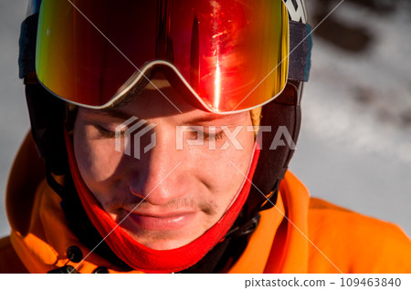 cheerful skier with his eyes closed, stands and smiles. Happy man enjoying holiday in winter season 109463840