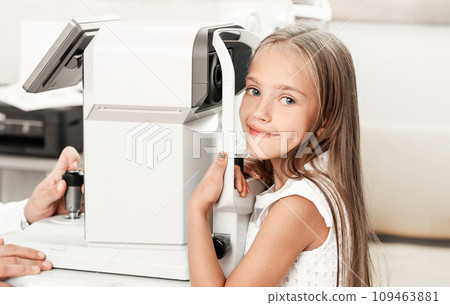 Happy little girl at ophthalmological clinic with modern equipment 109463881