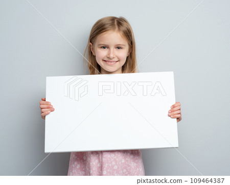 School girl holding horizontal blank white poster 109464387