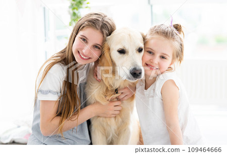 Little girls with cute dog in bright room Little girls with cute dog in bright room 109464666