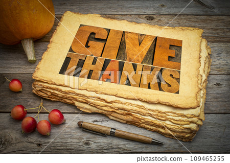 Give thanks word abstract in letterpress wood type on retro art paper with pumpkin and crab apples. Thanksgiving and fall holidays theme. Give thanks word abstract in letterpress wood type on retro art paper with pumpkin and crab apples. Thanksgiving and fall holidays theme. 109465255