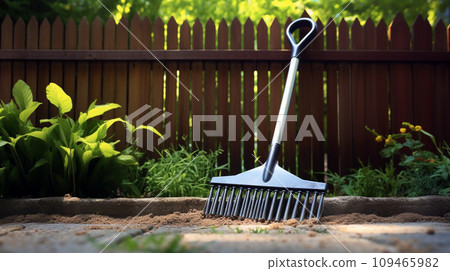 Rake Resting on Fence Rake Resting on Fence 109465982