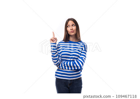 young european model woman wears a sweater with a sailor striped pattern points her hand to the side 109467118