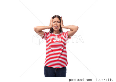 young upset brunette woman in a red striped t-shirt holding her head 109467119