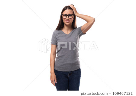 portrait of a caucasian slim young woman in glasses dressed in a gray basic t-shirt and jeans portrait of a caucasian slim young woman in glasses dressed in a gray basic t-shirt and jeans 109467121