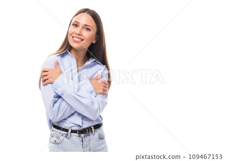 pretty young brunette european woman dressed in blue shirt over isolated background with copy space 109467153
