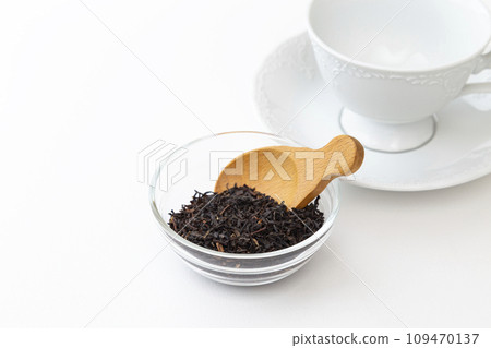 Tea leaves and cup and saucer white background 109470137