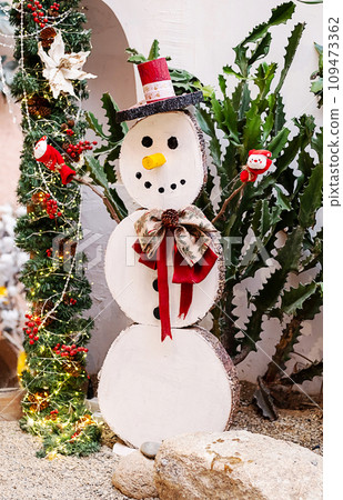 Wooden Christmas snowman in summer. Wooden Christmas snowman in summer. 109473362