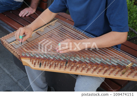 hands of musician playing on cimbalom or dulcimer, hands of musician playing on cimbalom or dulcimer, 109474151