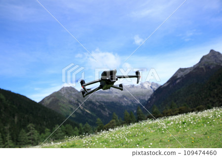 Flying drone in high altitude mountains 109474460